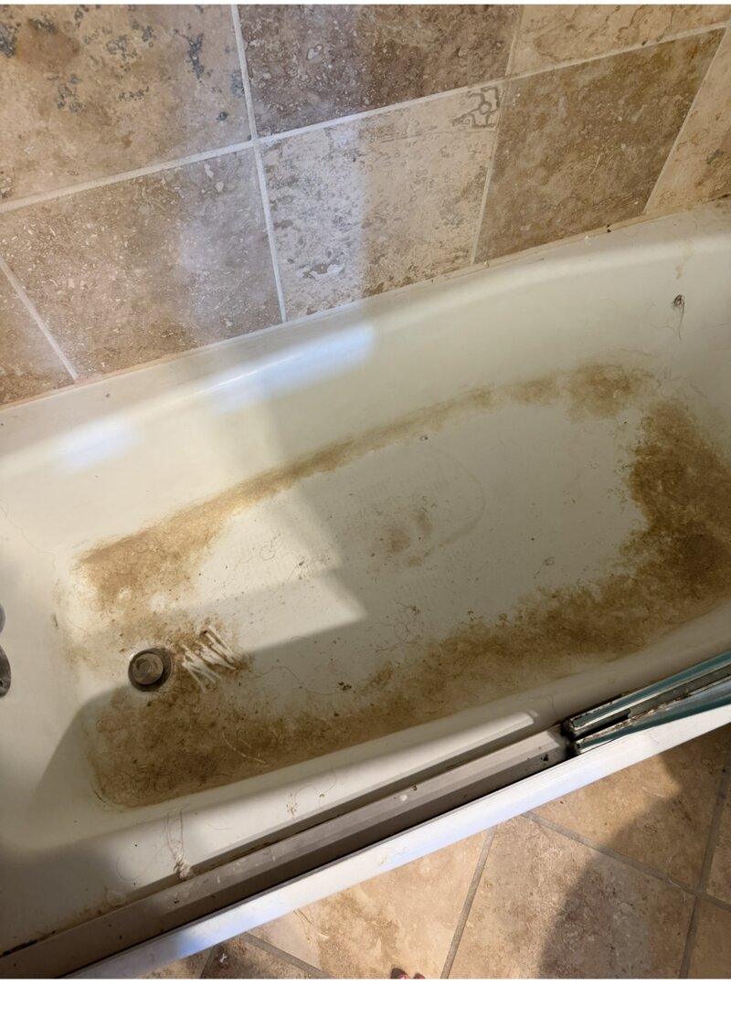 Bathtub before cleaning — heavy grime and staining