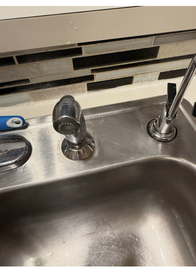 Sink sprayer after cleaning — polished chrome