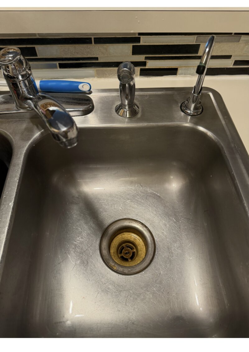 Kitchen sink after cleaning — polished stainless steel