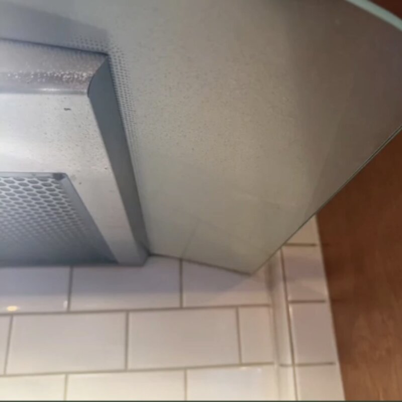Stove hood before cleaning — grease film and buildup